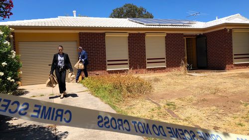 Police remove evidence from the Adelaide home this morning.