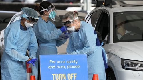 Staff prepare to collect samples at a drive-through COVID-19 testing clinic at Bondi Beach in Sydney, Australia.