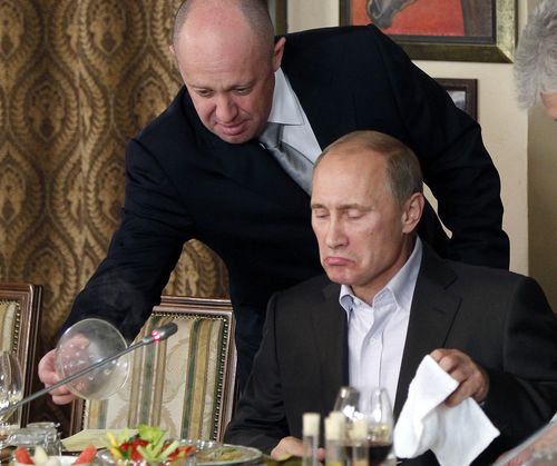 Yevgeny Prigozhin serves food to then-Russian Prime Minister Vladimir Putin at Prigozhin's restaurant outside Moscow, Russia during 2011.