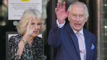 King Charles III and Queen Camilla wave as they arrive for a visit to University College Hospital Macmillan Cancer Centre in London, Tuesday, April 30, 2024.