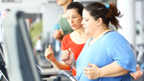 Exercising woman running on treadmill