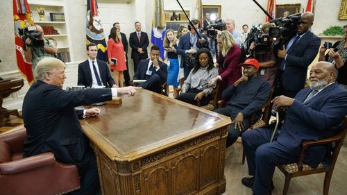 President Donald Trump, left, meets with rapper Kanye West, seated second from right, in the Oval Office of the White House in Washington on October. 11, 2018. 