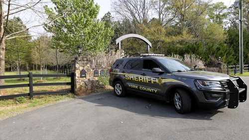 A York County sheriff's deputy is parked at 4456 Marshall Road, Rock Hill, S.C., Thursday, April 8, 2021, the sight where five people were killed on April 7, 2021. 