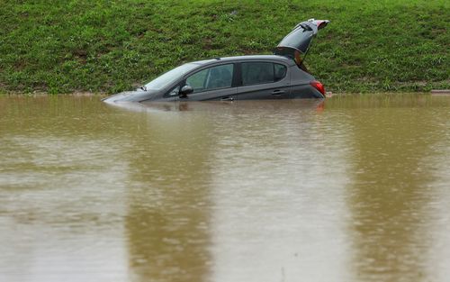 A car is immersed in water during floods in Medvode, Slovenia, August 4, 2023. REUTERS/Borut Zivulovic