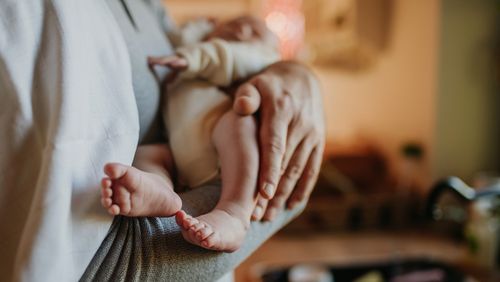 Close-up of father holding his little new born baby.