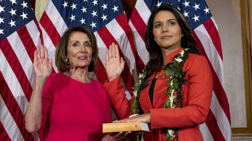 Tulsi Gabbard (right) is sworn into Congress by Speaker Nancy Pelosi.