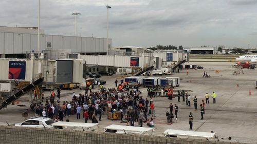 Hundreds of people stood on the tarmac after the shooting. (Reuters)