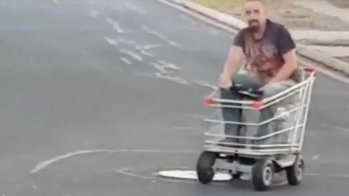 The man flashes a grin before continuing to cruise down the suburban street. (Lisa Burgess)