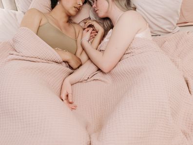Stock photo of two women in bed together.