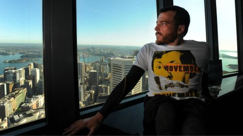 Fearnley takes in the view after crawling up the Sydney Tower Eye. (AAP)