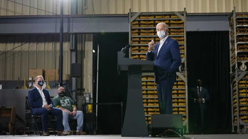 Joe Biden speaks to a socially distanced group at a factory in Wisconsin.