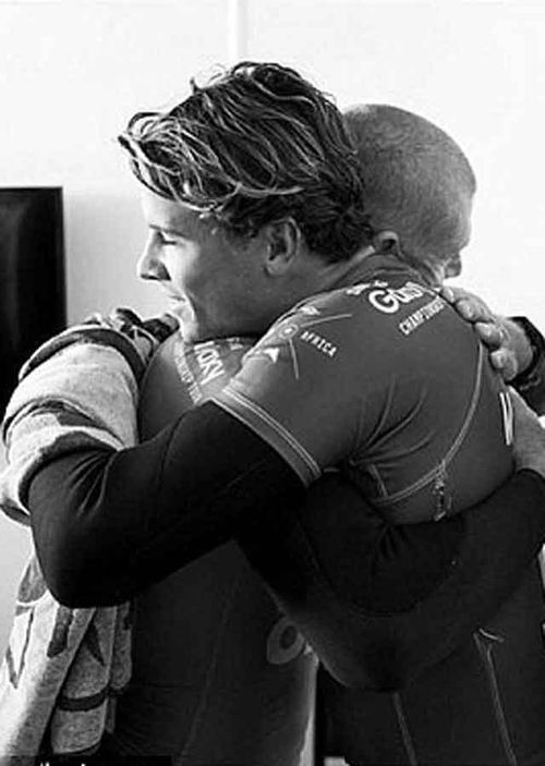 Aussies Mick Fanning and Julian Wilson locked in a hug after the terrifying shark attack in South Africa.