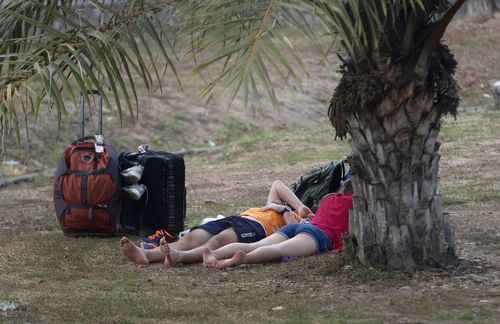 With so many hotels damaged, some tourists were forced to seek shelter elsewhere - including many of the beaches. Picture: AAP.