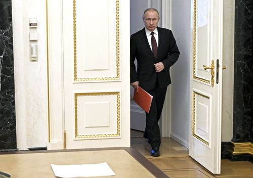  Russian President Vladimir Putin enters a hall to chair a Security Council meeting in Moscow, Russia, Friday, Feb. 25, 2022 