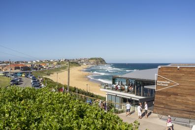 Newcastle, Australia - January 1, 2012: Merewether Beach, with the popular Merewether Surfhouse at the southern end of the beach, in Merewether, Newcastle, NSW, Australia