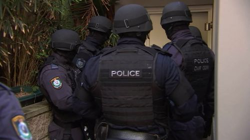 Police attend the raid in the suburb of Vaucluse.