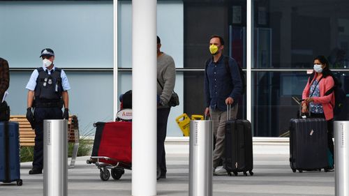 Returning passengers at Adelaide Airport.