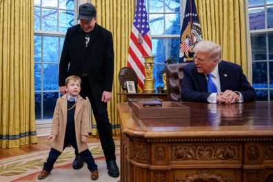 WASHINGTON, DC - FEBRUARY 11: Tesla and SpaceX CEO Elon Musk, joined by his son "X", appears next to U.S. President Donald Trump as he speaks during an executive order signing in the Oval Office at the White House on February 11, 2025 in Washington, DC. Trump is to sign an executive order implementing the Department of Government Efficiency's (DOGE) "workforce optimization initiative," which, according to Trump, will encourage agencies to limit hiring and reduce the size of the federal governmen