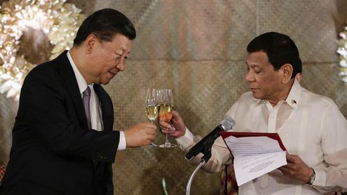 Philippine President Rodrigo Duterte, right, proposes a toast to Chinese President Xi Jinping during a state banquet at Malacanang Palace in Manila, Philippines