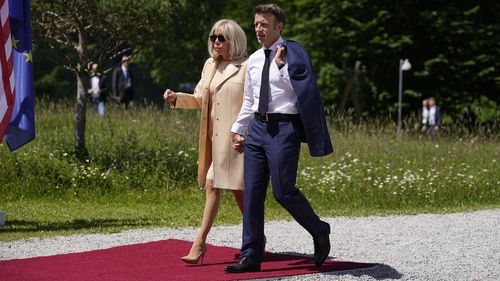 French President Emmanuel Macron and his wife Brigitte during the official G7 summit welcome ceremony at Castle Elmau in Kruen, near Garmisch-Partenkirchen, Germany, on Sunday, June 26, 2022. The Group of Seven leading economic powers are meeting in Germany for their annual gathering Sunday through Tuesday. (AP Photo/Martin Meissner)