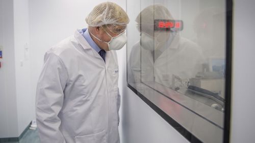 Britain's Prime Minister Boris Johnson visits the French biotechnology laboratory Valneva in Livingston, Scotland, Thursday Jan. 28, 2021, where they will be producing a COVID-19 vaccine on a large scale, during a visit to Scotland