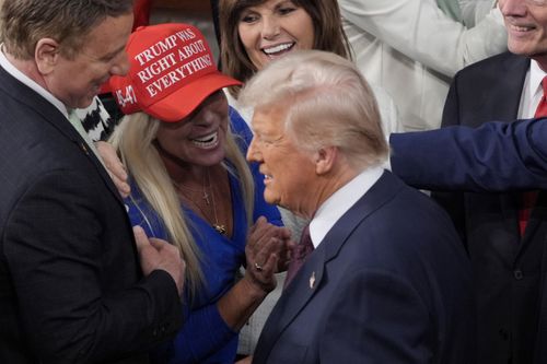 President Donald Trump arrives and walks by Rep. Marjorie Taylor Greene, R-Ga., to address a joint session of Congress at the Capitol in Washington, Tuesday, March 4, 2025. 
