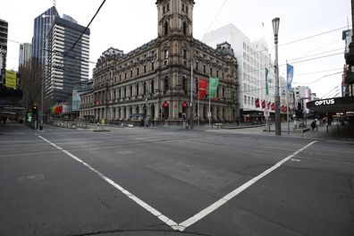 MELBOURNE, AUSTRALIA - JULY 20: A quiet intersection is seen along Bourke Street on July 20, 2021 in Melbourne, Australia. Victoria is under strict lockdown as the state continues to record new community COVID-19 cases and work to stop the spread of the highly infectious delta coronavirus strain in the community. (Photo by Daniel Pockett/Getty Images)