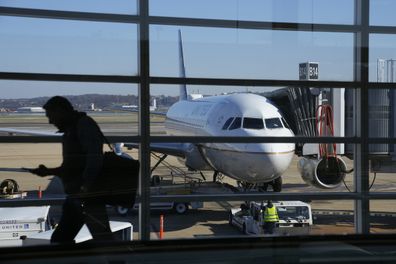 File - A United Airlines plane sits at a gate at Ronald Reagan Washington National Airport in Arlington, Va., Nov. 23, 2022. United Airlines says that it will start boarding passengers in economy class with window seats first starting next week, a move that will speed up boarding times for flights. (AP Photo/Patrick Semansky, File)