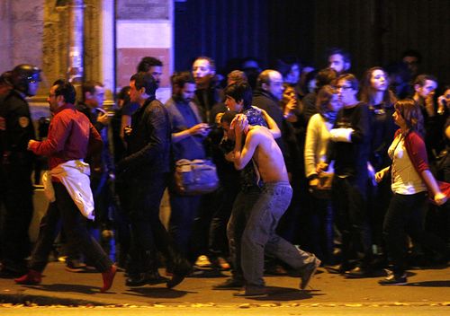 Wounded people are evacuated outside the scene of a hostage situation at the Bataclan theatre in Paris, France, 14 November 2015. Dozens of people have been killed in a series of attacks in the French capital Paris
