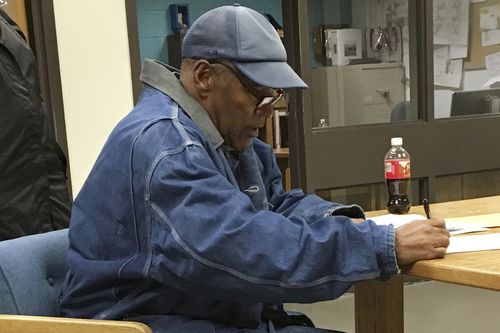 Simpson signing documents at the Lovelock Correctional Center. (AP)