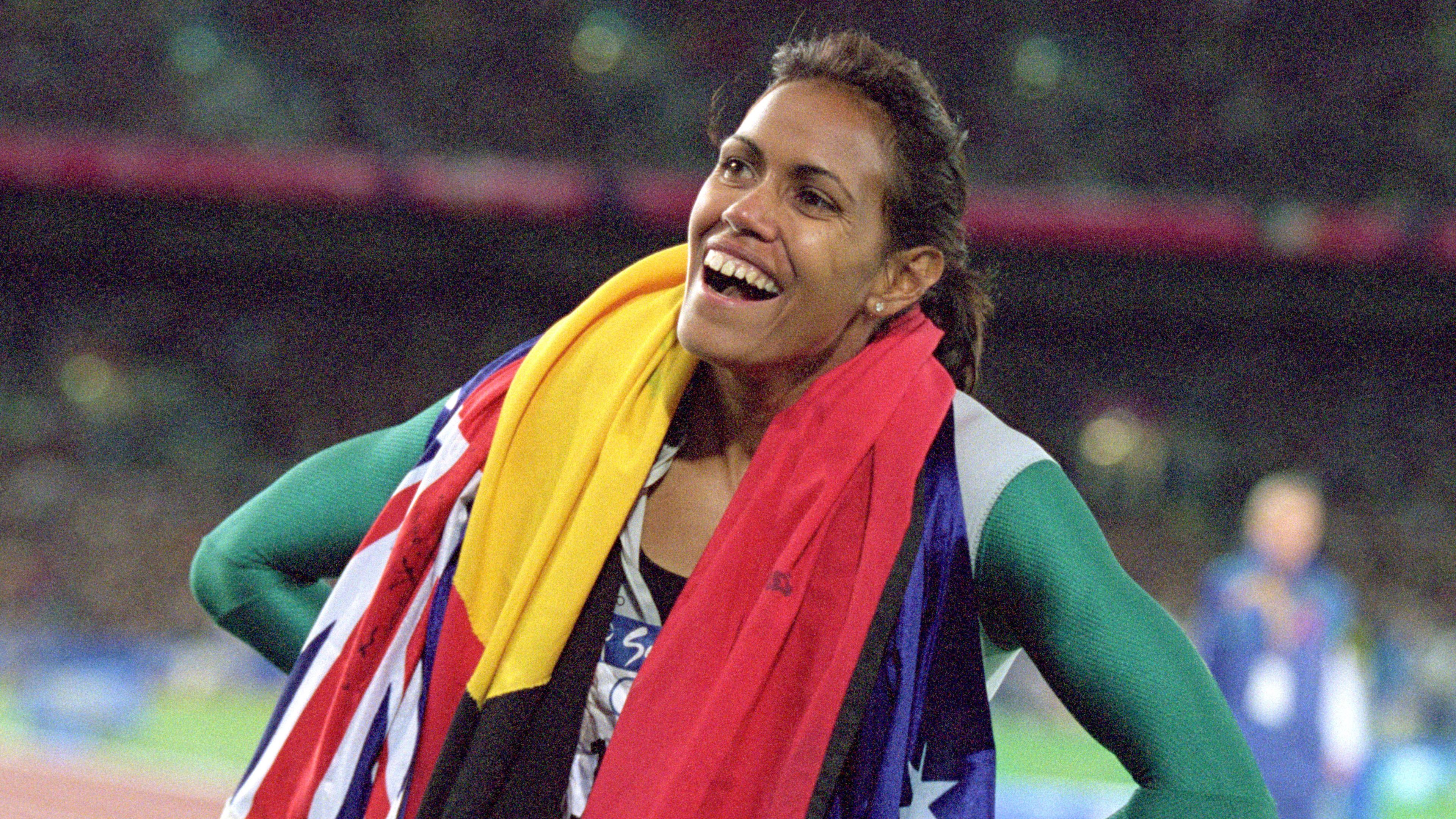 Cathy Freeman of Australia is elated after winning gold in the 400m final during the 2000 Sydney Olympic Games. 