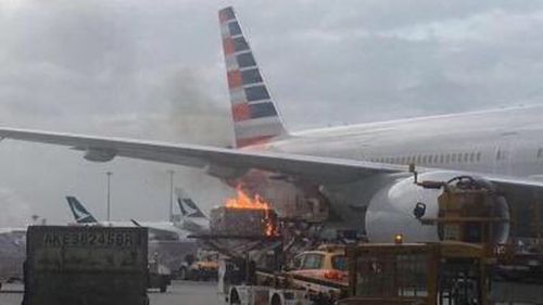 Cargo catches fire as it's loaded into an American Airlines plane in Hong Kong. (Twitter)