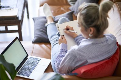 work from home flexible work arrangements laptop sitting on couch woman