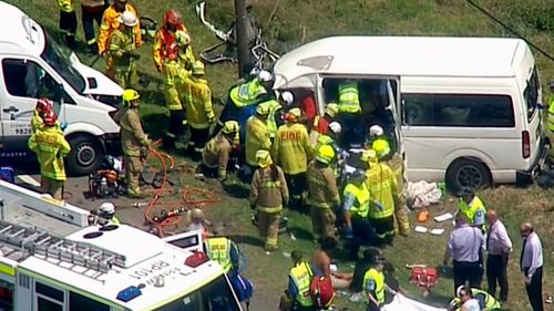 Twelve ambulances and fire crews are at the site of the head-on collision in Kemps Creek (9NEWS)