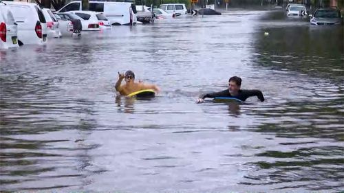 NSW weather update; floods northern beaches kids play