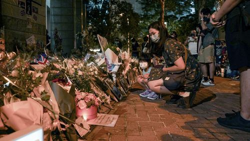 Over 2,500 people lined up to offer condolences to Queen Elizabeth II outside the British consulate in Hong Kong on September 12.