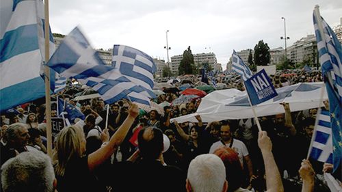 Queues were reported at every ATM in Athen's on Friday with a 60 euro limit per person per day imposed. (Supplied)