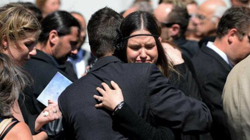 Mourners comfort each other at the memorial service for Bianka and Jude O'Brien, at St Joseph's Catholic Church, Rozelle. (AAP)