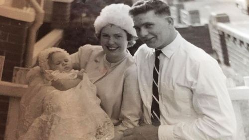 Kim, pictured with her mother Jean and father Alan, on her christening day.