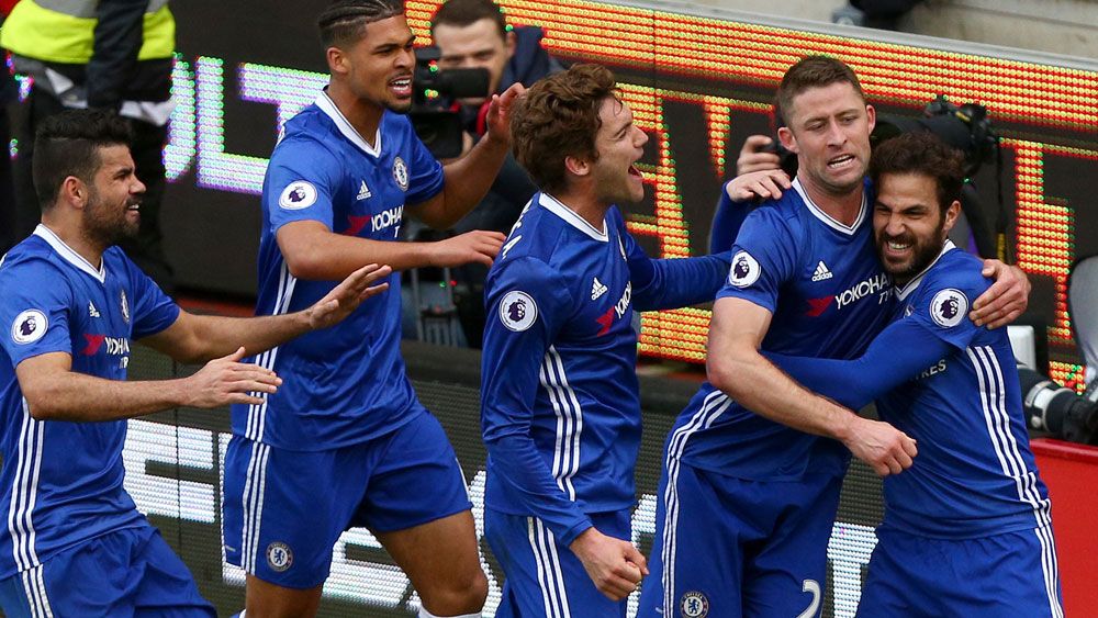 Chelsea's Gary Cahill is swamped by team-mates after scoring the winner. (AAP)