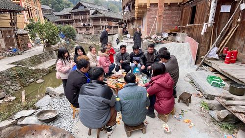 Dali villagers gather around a short table for their Lunar New Year feast.