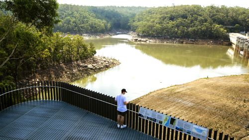 A man stands on  the viewing platform of Warragamba Dam on February 10, 2020 in Sydney, Australia.
