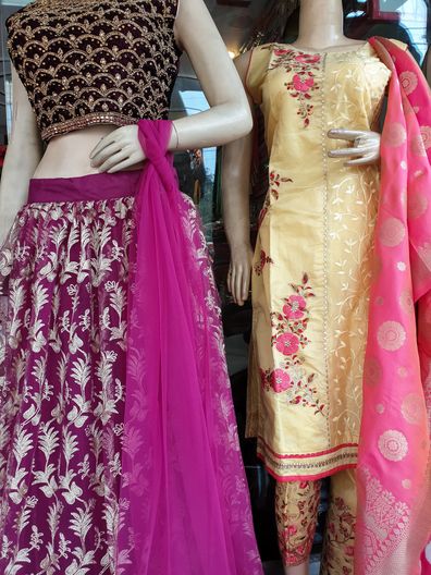 Multicolored lehenga and salwar kameez (Indian traditional dress) for sale in the market.