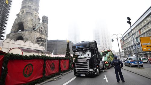 Murder weapon: Experts examine the scene around a truck that crashed into a Christmas market in Berlin. Source: AFP