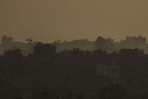 Destroyed buildings in the Gaza Strip are seen during the sunset from southern Israel, Thursday, May 9, 2024. 