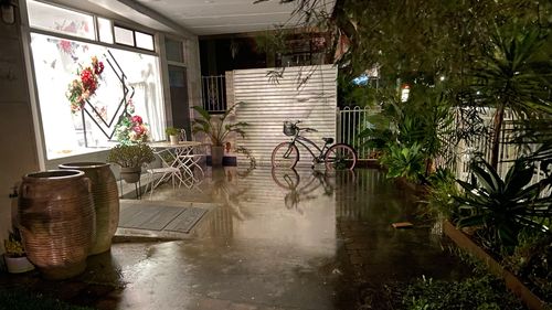Kurnell residents woke to floodwaters mixed with fuel and oil this morning after heavy rain saw a  retention pit overflow.