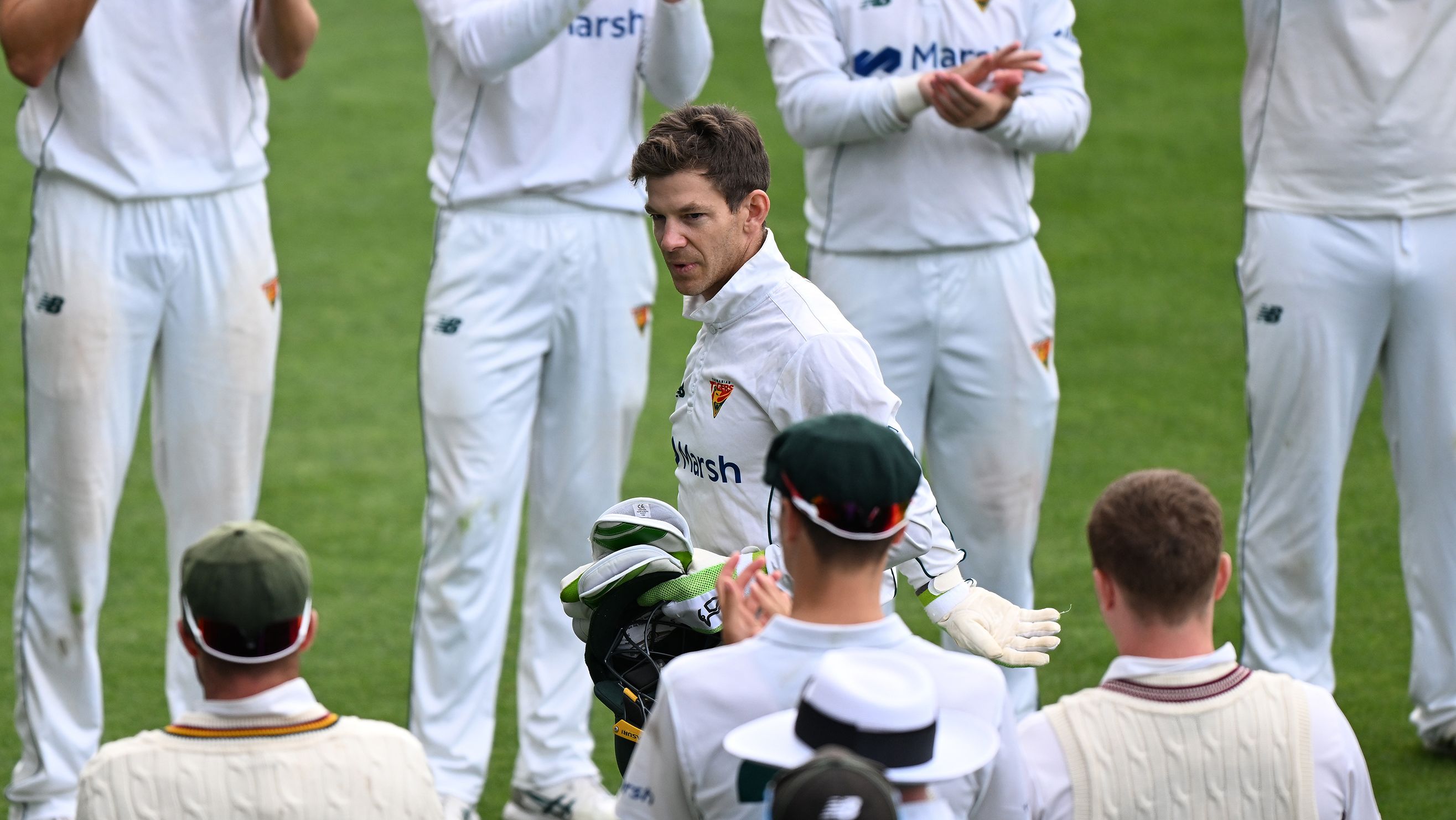 Tim Paine is acknowledged by players as he leaves the field during the Sheffield Shield match between Tasmania and Queensland.