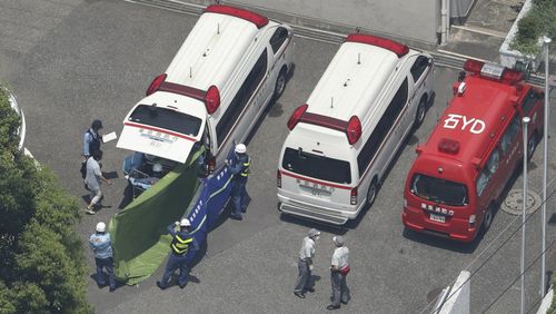 An aerial photo shows ambulances taking students to a hospital due to suspicion of heatstroke at Oizumisakura high school in Nerima Ward, Tokyo. Picture: AAP