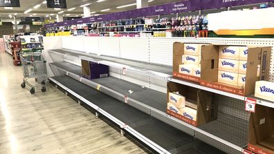 Bare toilet paper and tissue shelves in Sydney supermarket.