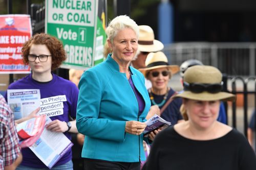 Independent candidate for Wentworth Kerryn Phelps is seen handing out how to vote cards at a polling place at Bellevue Hill.